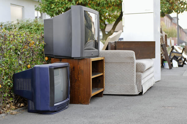 Bild vergrößern: Ein Sofa, zwei Rhrenfernseher, ein weier Khlschrank sowie weitere Sperrmllartikel und Elektro-Altgerte werden auf dem Gehweg zur Abholung bereitgestellt.