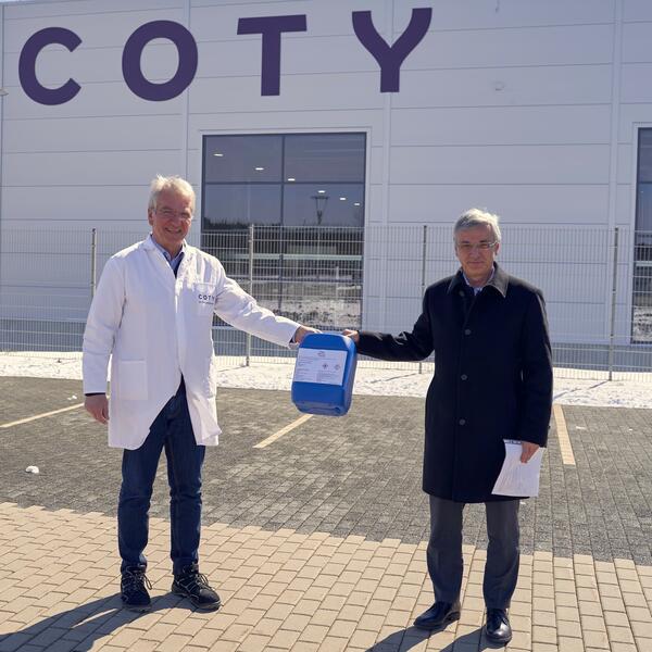 Bild vergrößern: Coty-Werkleiter  Ulrich Jähn (links) übergibt an Landrat Rolf Keil  eine Spende von  Handdesinfektionsmitteln.